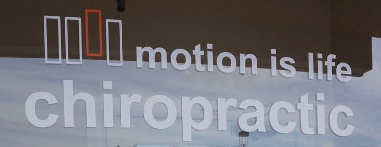 motion is life chiropractic window sign